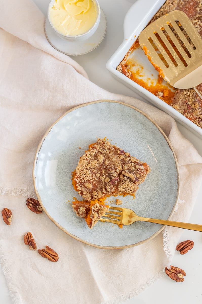 Overhead of sweet potato casserole with pecans on a plate