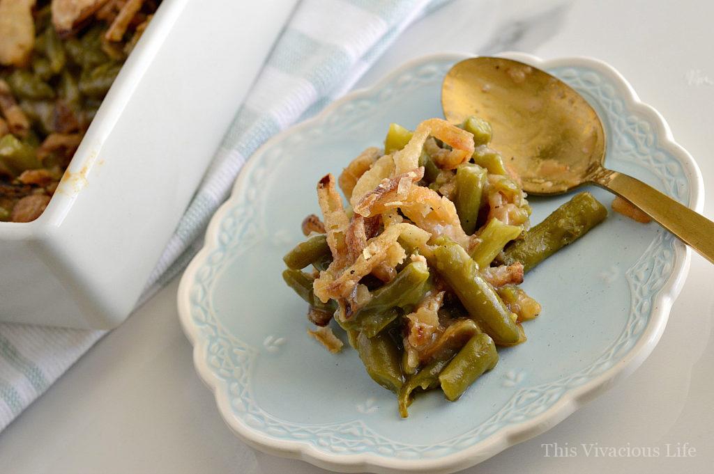 Gluten-free green bean casserole on a blue plate with gold spoon