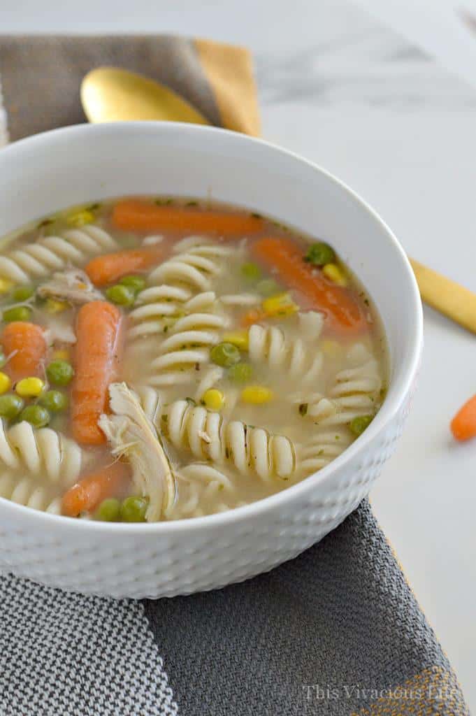 Gluten-free chicken noodle soup in a white bowl
