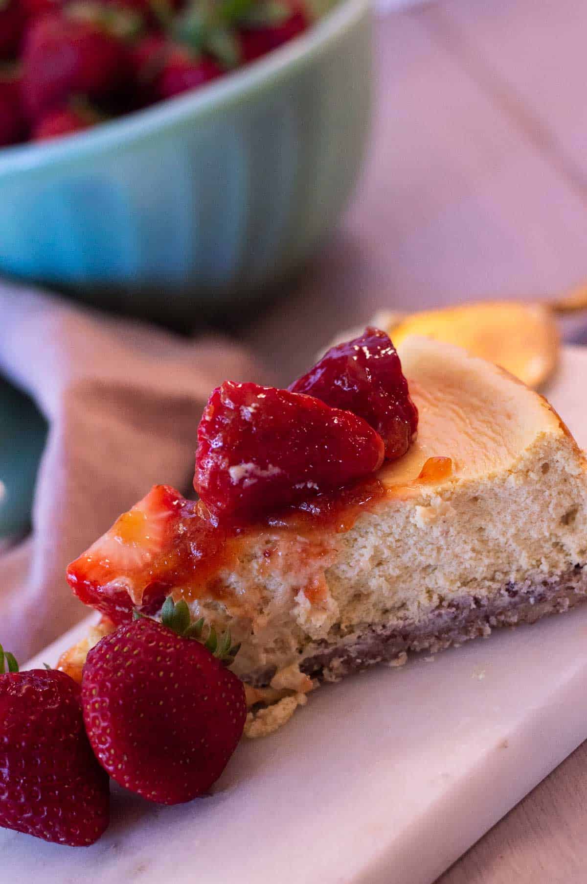 gluten free cheesecake on a jadeite cake stand
