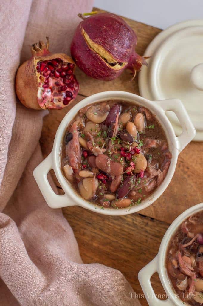 This slow cooker ham and bean soup is so warm and filling. The fresh pomegranate adds so much freshness! While you can let it sit and cook all day in the slow cooker, you can also whip it up even quicker in your Instant Pot. Either way, it is sure to fill hungry bellies during those cold winter months. I love the this soup is great for using your leftover Thanksgiving ham! || This Vivacious Life #slowcooker #souprecipe #ham #thisvivaciouslife
