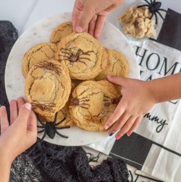 Spider chocolate chip cookies! These delicious and spooky Halloween cookies are sure to please any little ghost or goblin. They only take a few extra minutes from your classic gluten-free chocolate chip cookie too.