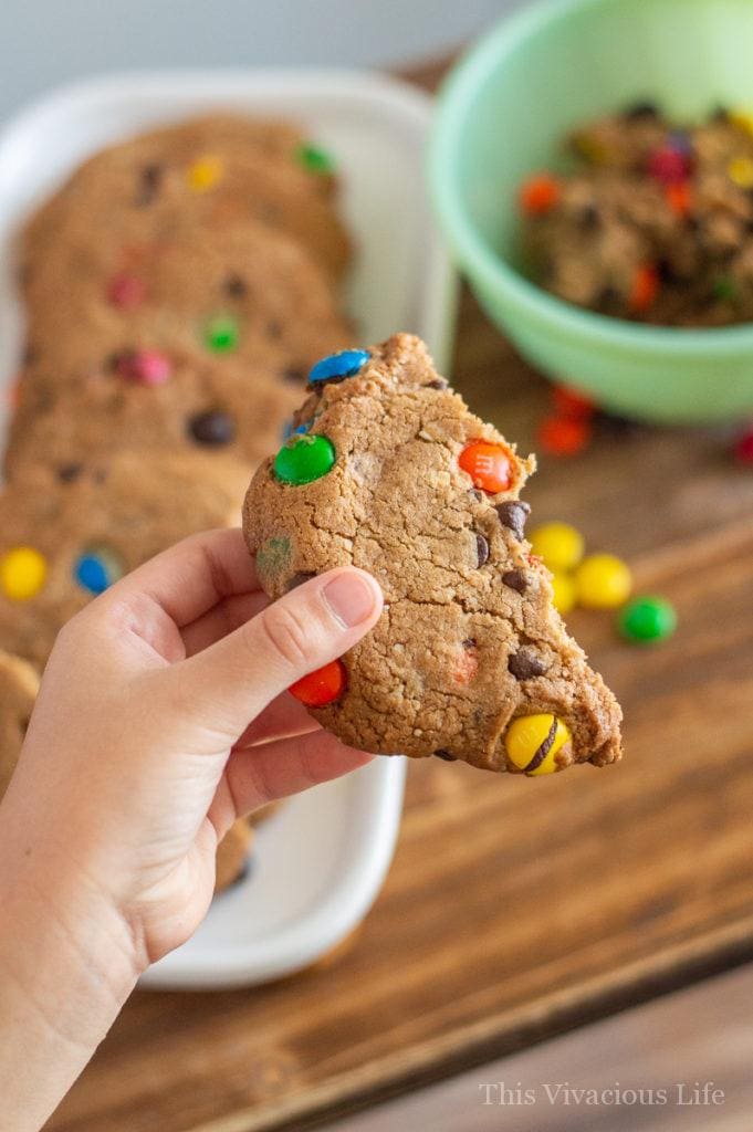 Half a gluten-free monster cookie in a little kids hand