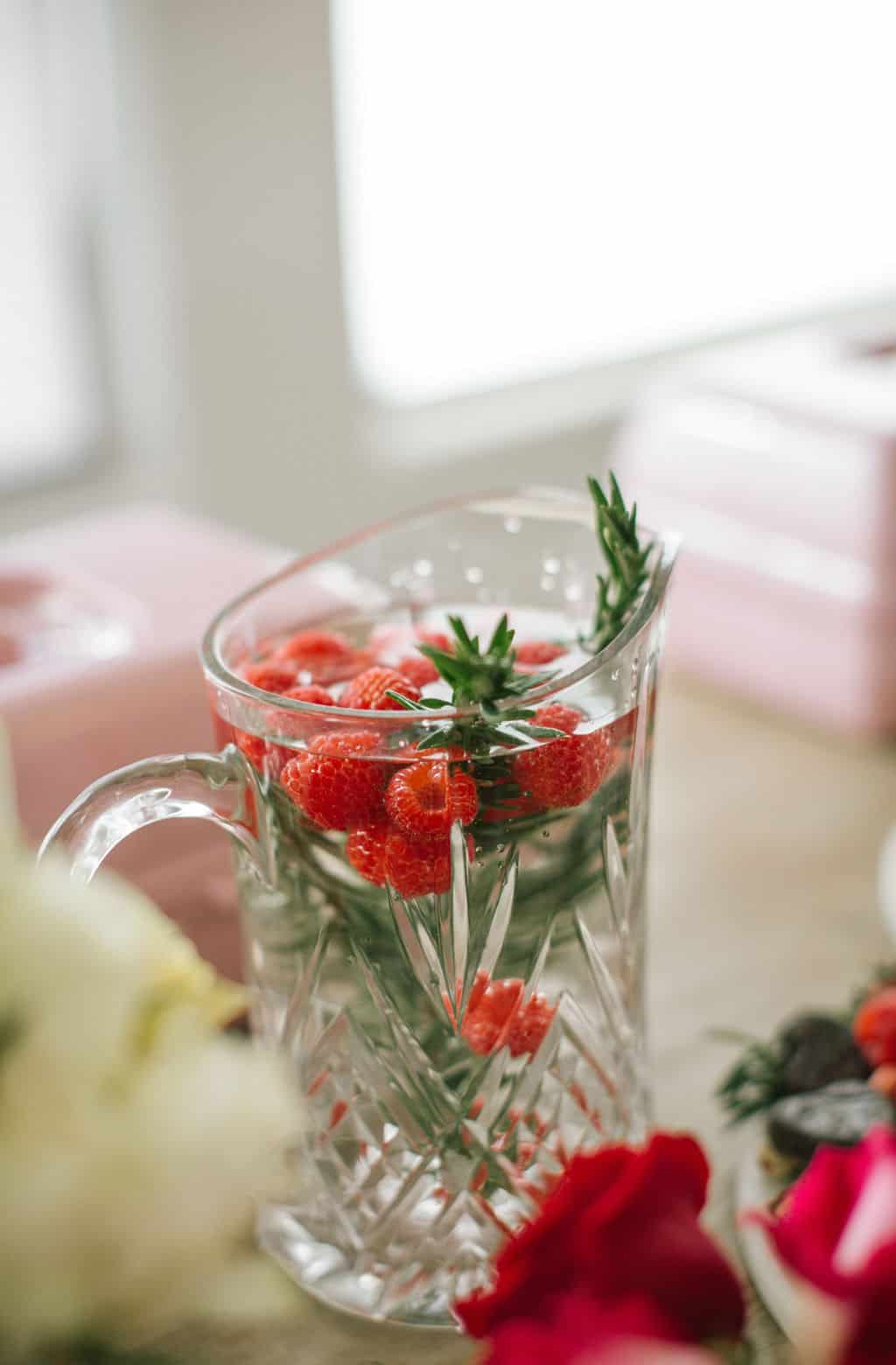 Raspberry rosemary mocktail in crystal pitcher