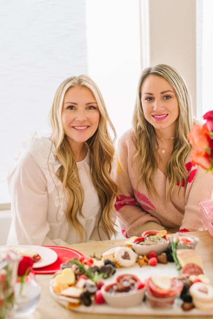 Two girls smiling at a Valentines table