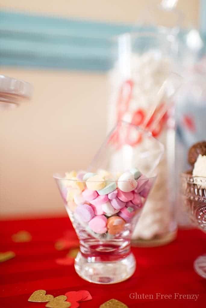Galentines Day Favorite Things Party as featured on Hostess with the Mostess! Have you been wanting to create the perfect girls night in for Galentines Day? This party is so fun and easy to put together. From the sweets and cocoa bar, including ooey gooey red velvet cookies (recipe included), to a fries before guys bar, this party has it all. There is even a kiss "kard" making station for writing up something kind for your cutie. Each girl brings a few of their favorite things and everybody goes home with the same amount they brought. So fun! There is even a philanthropy aspect with blessing bags they made for the local homeless shelter. Get all the details and photos for this epic DIY party on glutenfreefrenzy.com. 