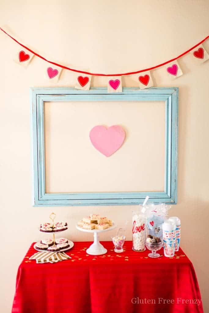 Galentines Day Favorite Things Party as featured on Hostess with the Mostess! Have you been wanting to create the perfect girls night in for Galentines Day? This party is so fun and easy to put together. From the sweets and cocoa bar, including ooey gooey red velvet cookies (recipe included), to a fries before guys bar, this party has it all. There is even a kiss "kard" making station for writing up something kind for your cutie. Each girl brings a few of their favorite things and everybody goes home with the same amount they brought. So fun! There is even a philanthropy aspect with blessing bags they made for the local homeless shelter. Get all the details and photos for this epic DIY party on glutenfreefrenzy.com.
