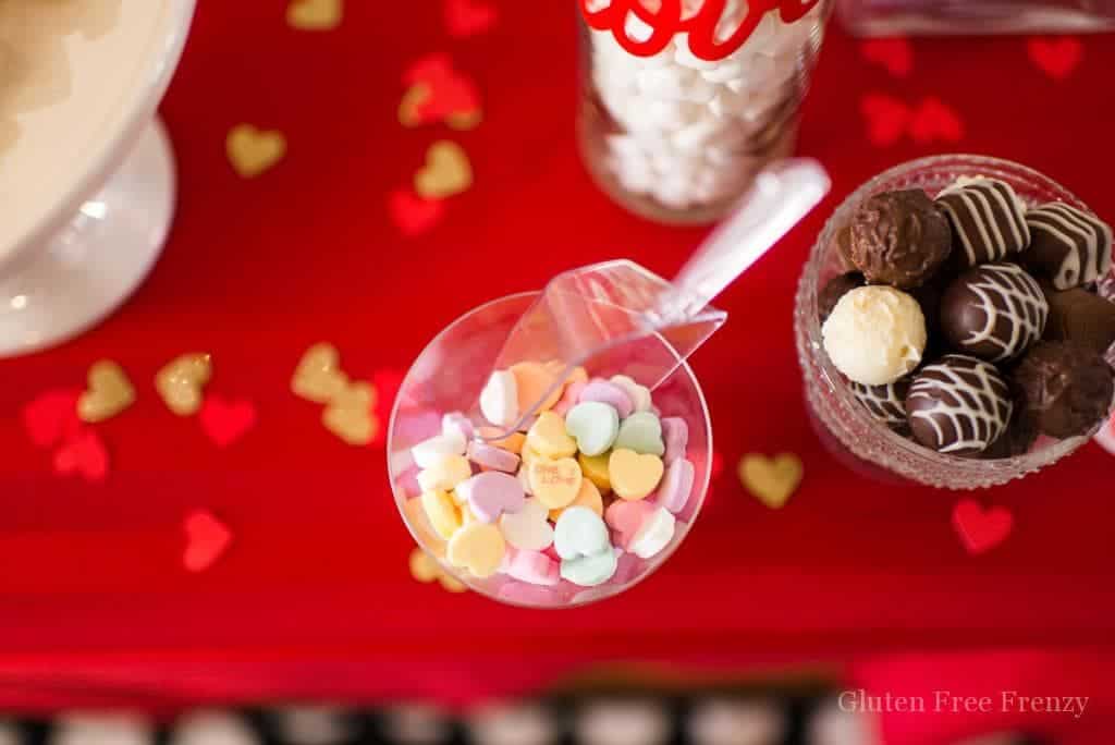 Galentines Day Favorite Things Party as featured on Hostess with the Mostess! Have you been wanting to create the perfect girls night in for Galentines Day? This party is so fun and easy to put together. From the sweets and cocoa bar, including ooey gooey red velvet cookies (recipe included), to a fries before guys bar, this party has it all. There is even a kiss "kard" making station for writing up something kind for your cutie. Each girl brings a few of their favorite things and everybody goes home with the same amount they brought. So fun! There is even a philanthropy aspect with blessing bags they made for the local homeless shelter. Get all the details and photos for this epic DIY party on glutenfreefrenzy.com.