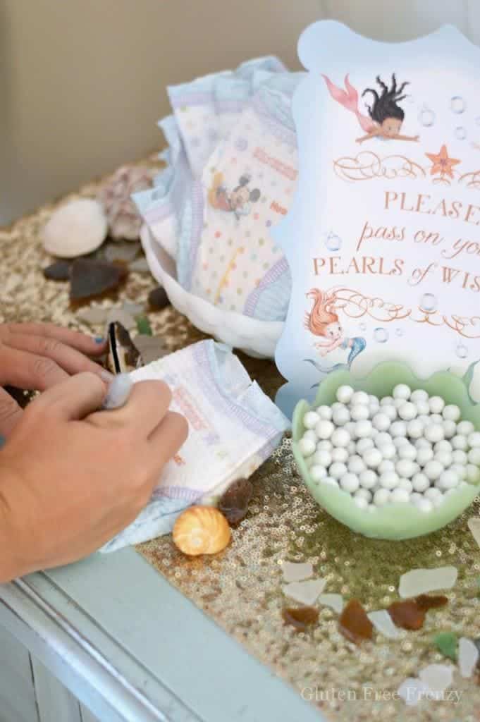 This mermaid themed baby shower couldn't be cuter! So great for little girls but also works as a gender neutral shower with all the white, baby blue and mint green. Clam cookies made from macaroons are so gorgeous and those little mermaids and mermaid tails were darling too! PLUS a DIY diaper cupcake tutorial and more... glutenfreefrenzy.com