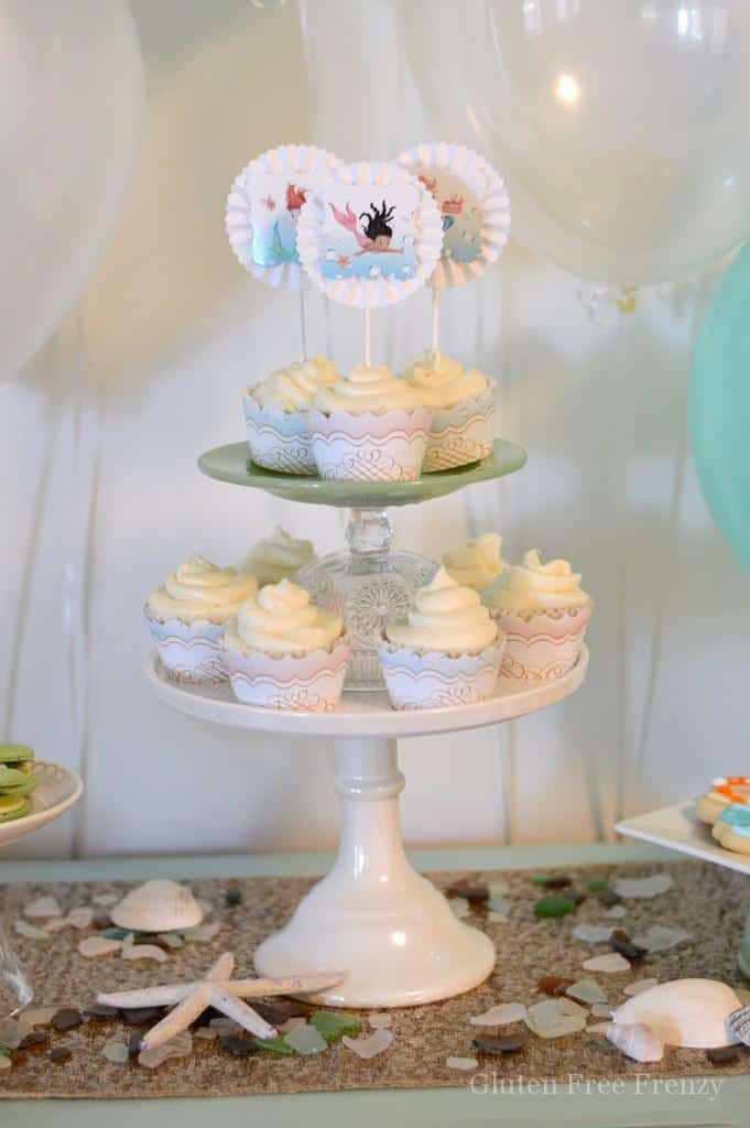 This mermaid themed baby shower couldn't be cuter! So great for little girls but also works as a gender neutral shower with all the white, baby blue and mint green. Clam cookies made from macaroons are so gorgeous and those little mermaids and mermaid tails were darling too! PLUS a DIY diaper cupcake tutorial and more... glutenfreefrenzy.com