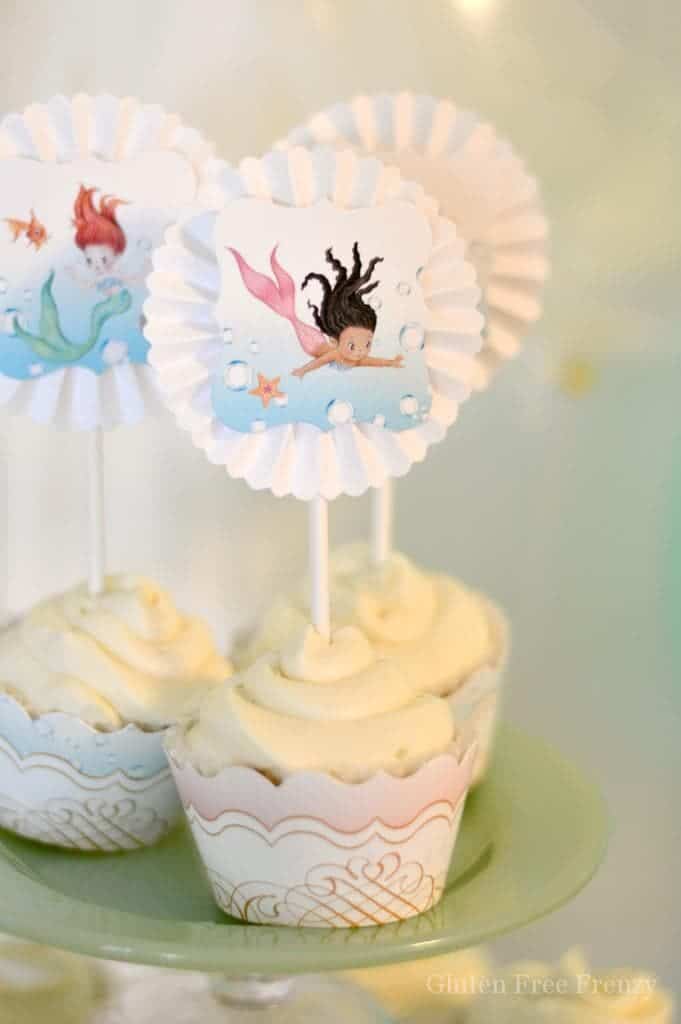 This mermaid themed baby shower couldn't be cuter! So great for little girls but also works as a gender neutral shower with all the white, baby blue and mint green. Clam cookies made from macaroons are so gorgeous and those little mermaids and mermaid tails were darling too! PLUS a DIY diaper cupcake tutorial and more... glutenfreefrenzy.com