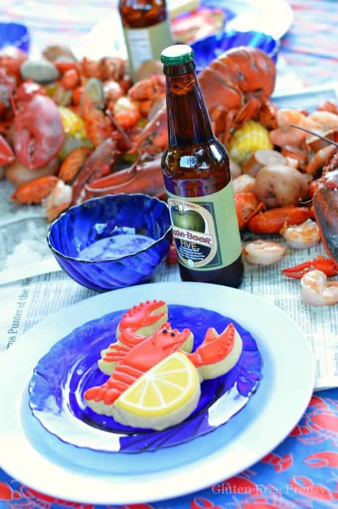 This lobster boil party is so fun! If you have always wanted to host a seafood boil or clambake, this party is for you! Complete with lobster and lemon decorated sugar cookies, Old Bay popcorn and LOTS of seafood. Get all the details for throwing your own at glutenfreefrenzy.com