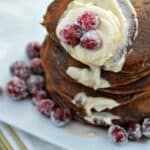 Gingerbread Pancakes with Sugared Cranberries on a white plate