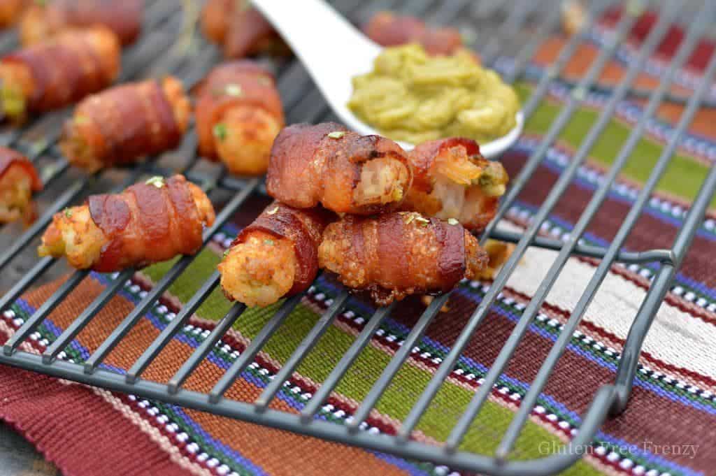 Guacamole stuffed tater tot bacon bombs are going to be a HUGE hit at your next gathering. They are the perfect appetizer for New Years Eve or Superbowl.
