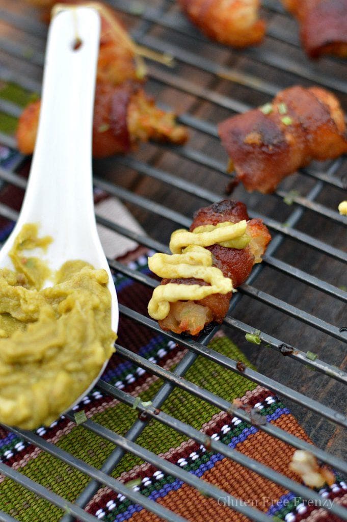 Guacamole stuffed tater tot bacon bombs are going to be a HUGE hit at your next gathering. They are the perfect appetizer for New Years Eve or Superbowl. 