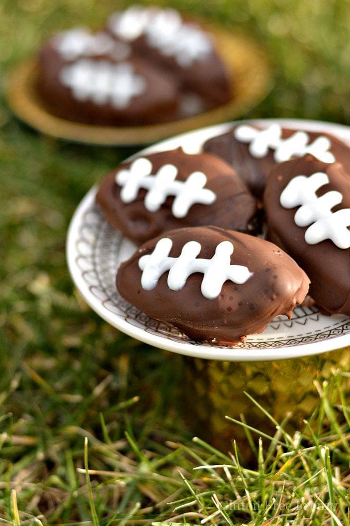 Chocolate covered gluten-free cookie dough footballs on a plate