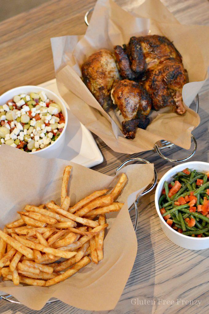 French fries, bean salad, green beans and a roasted chicken