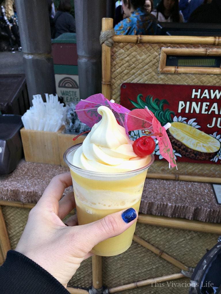 Disneyland Dole whip in a cup with a cherry and umbrella