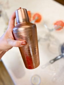 Gold cocktail shaker in hand