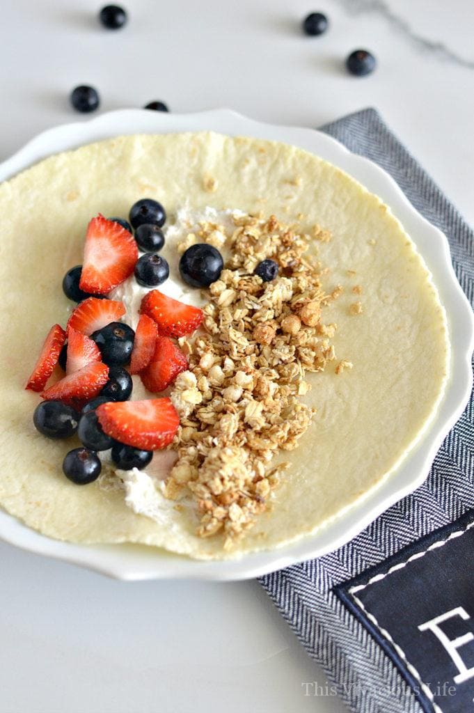 Sweet vegan breakfast burritos on a plate with a towel