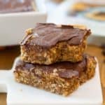 gluten-free peanut butter bars stacked on a marble board