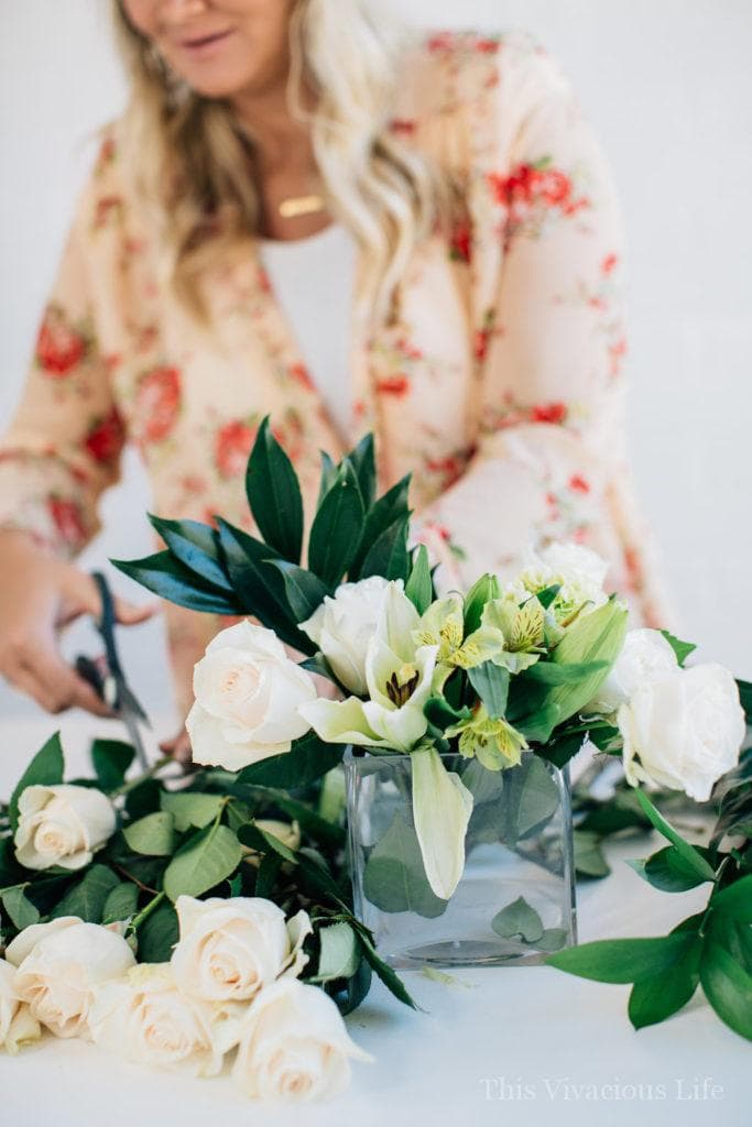 Greenery and white flowers being cut