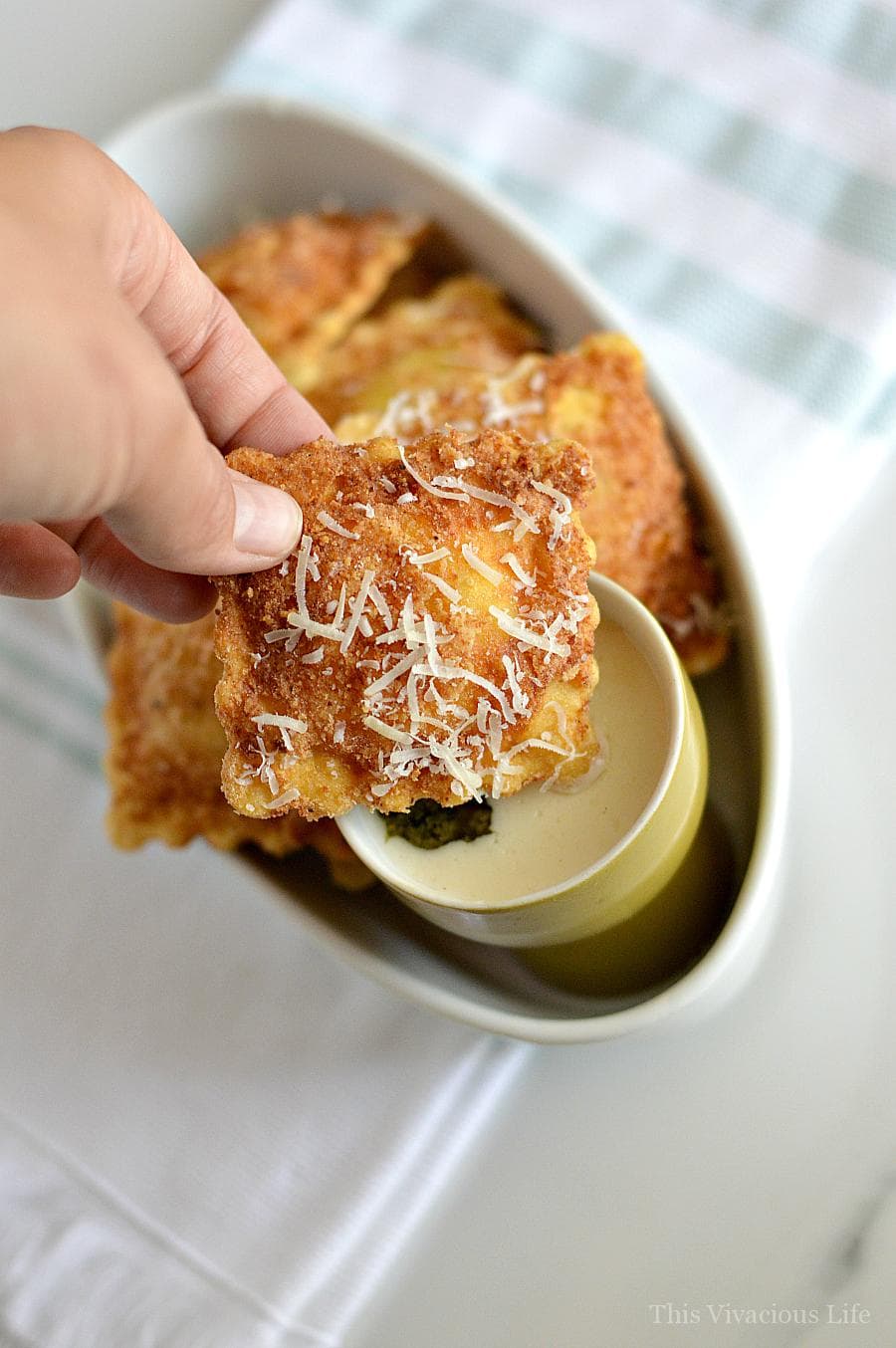 gluten-free fried ravioli with pesto Alfredo sauce