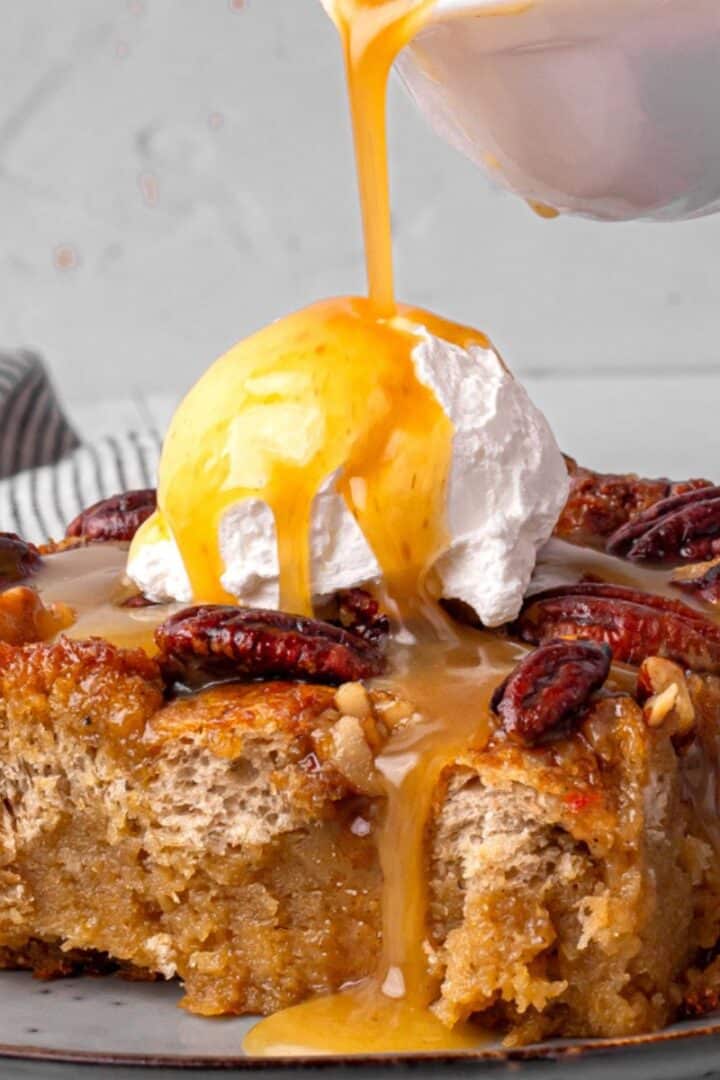 Pecan Pie Bread Pudding with Buttermilk Syrup being poured on top