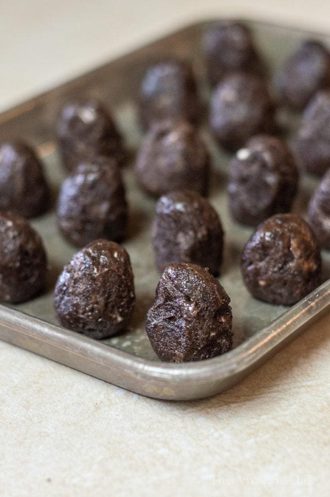 Chocolate cookie balls on a baking sheet 