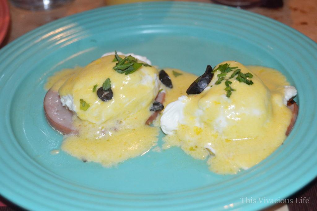 Gluten-free eggs Benedict on a blue plate