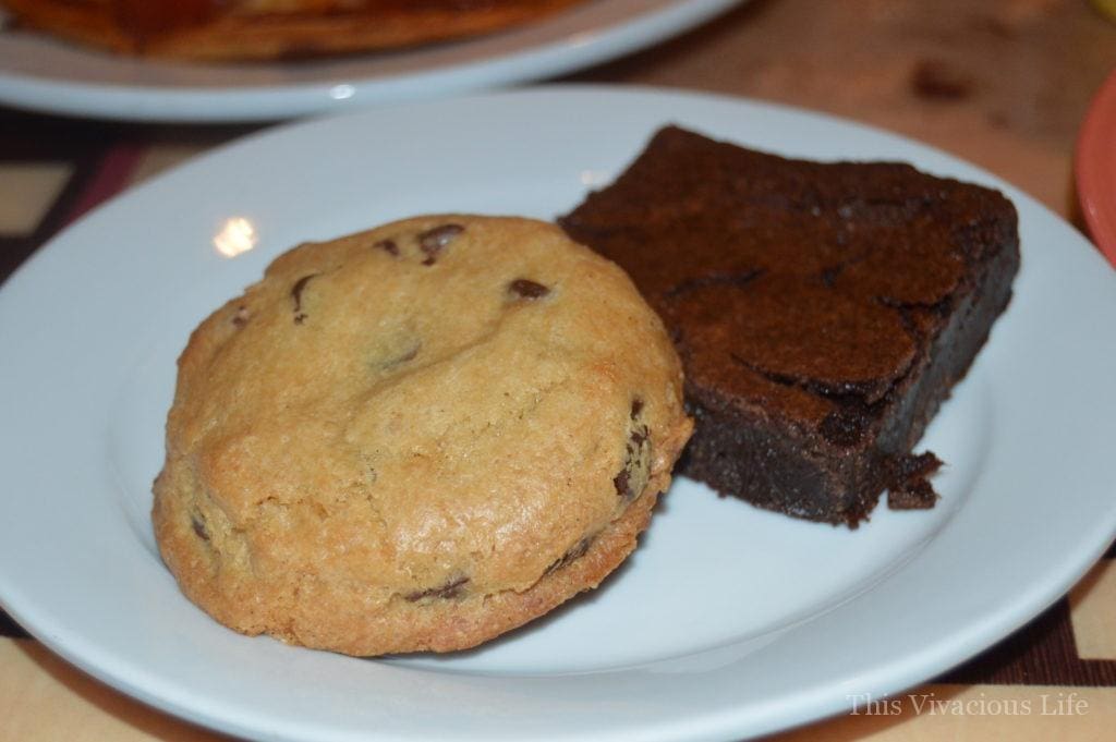 Gluten-free chocolate chip cookie and brownie on a white plate