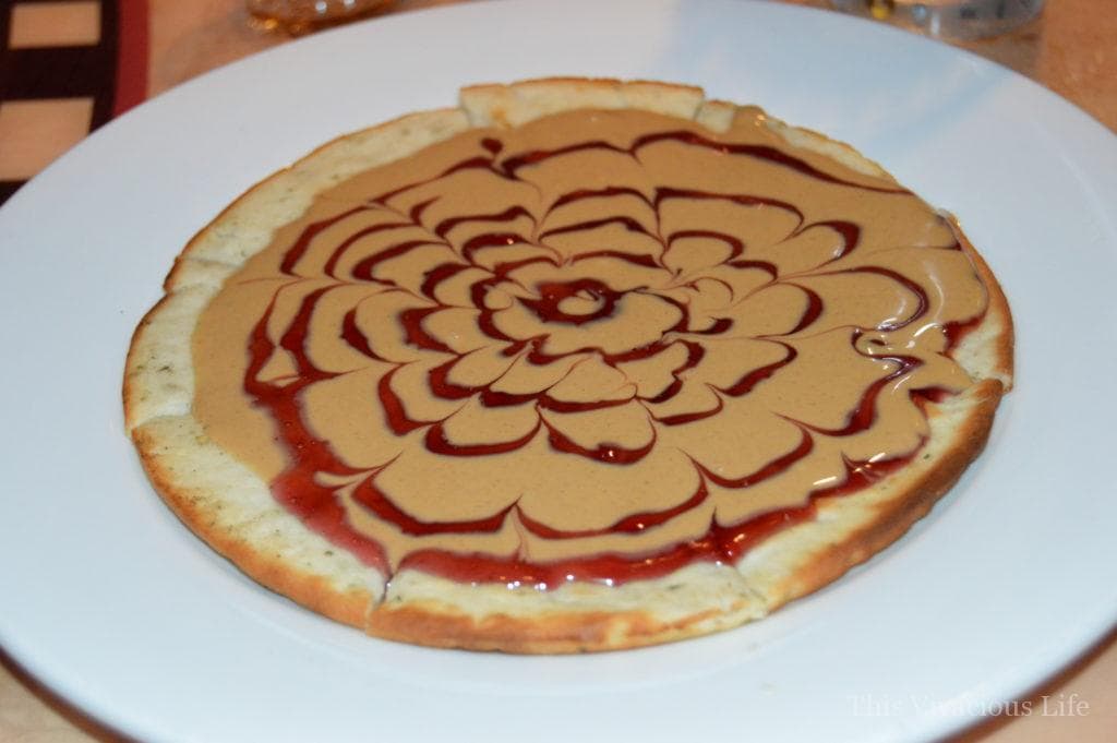 Gluten-free peanut butter and jelly pizza on a white plate