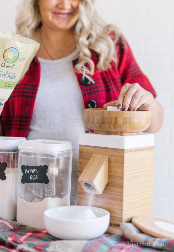 Wood Nutrimill flour grinder with blonde women behind it