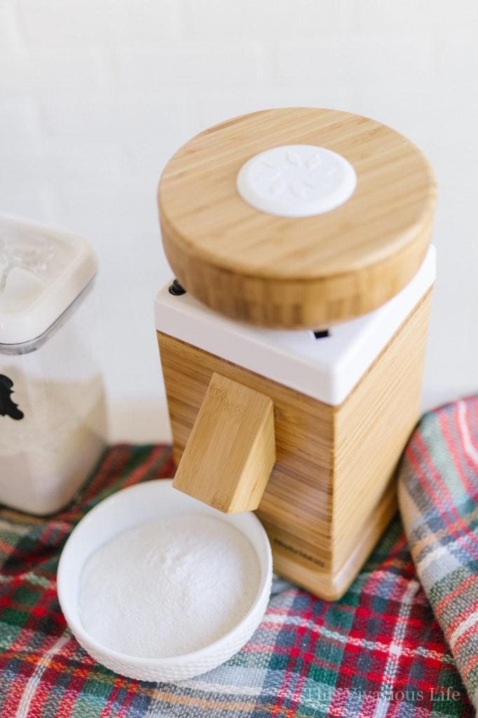 Wood Nutrimill flour grinder on a plaid blanket
