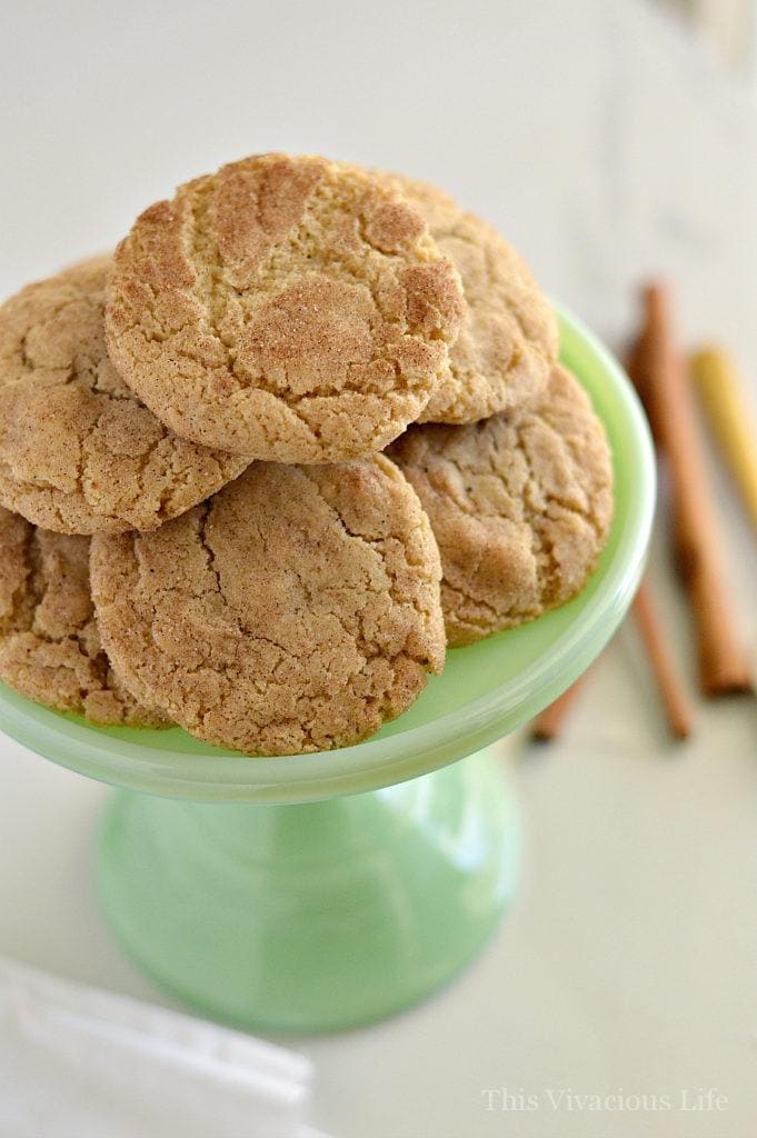 Snickerdoodles in a pile on a small jadeite cake stand