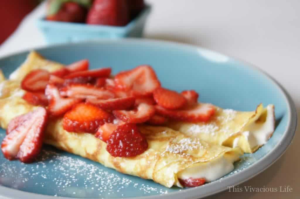 Gluten-free crepes with strawberries on a blue plate