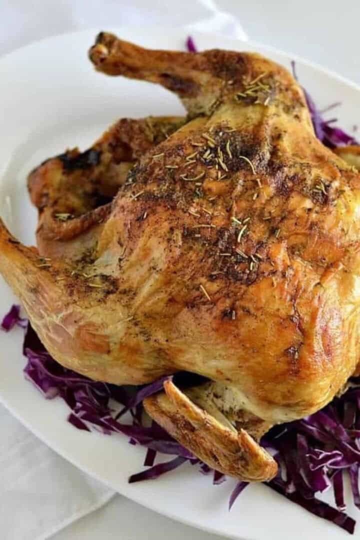 Dutch oven whole chicken on a white plate