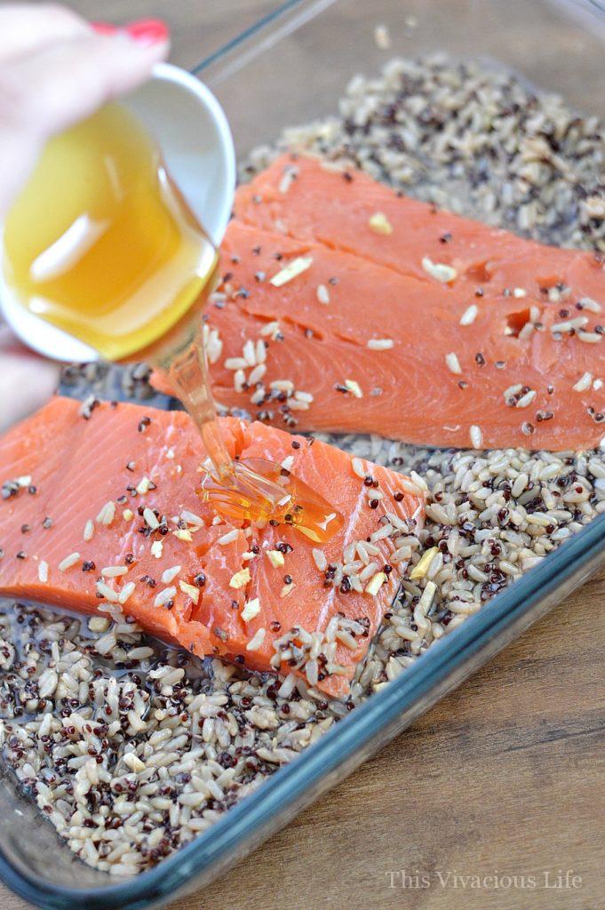 Salmon with honey poured on it in rice