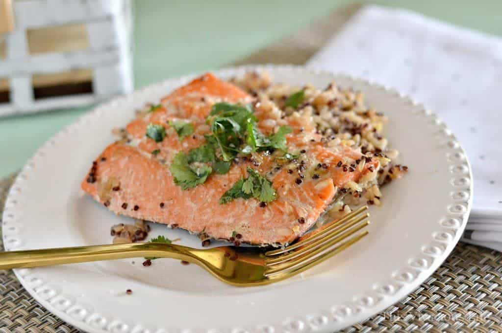 Sockeye salmon om a plate with fresh herbs