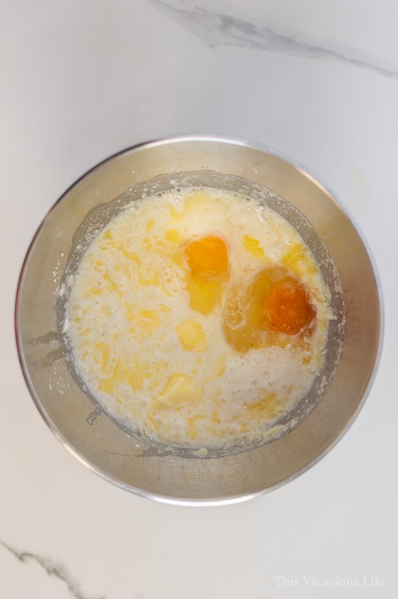 Pancake mix and eggs in a stainless steel bowl