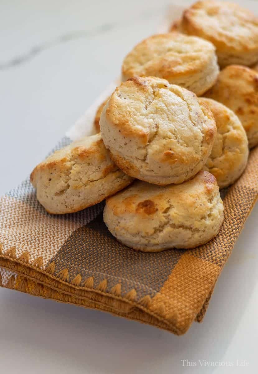 Lots of gluten-free biscuits on a yellow towel on marble