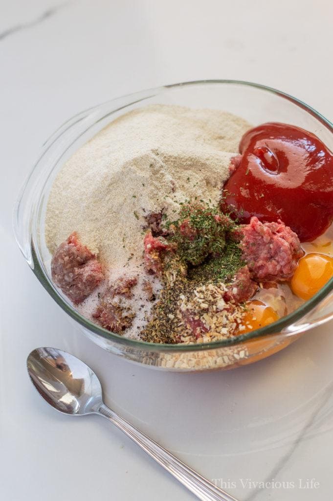 Meatloaf ingredients in a clear glass bowl