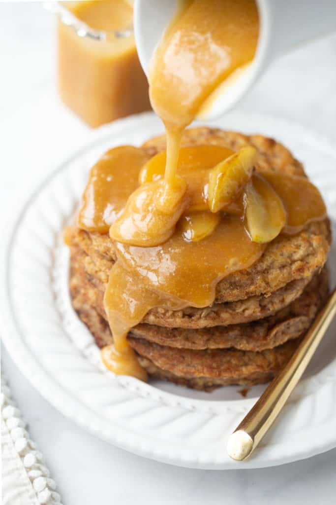 Gluten-free oatmeal pancakes on a plate with buttermilk syrup