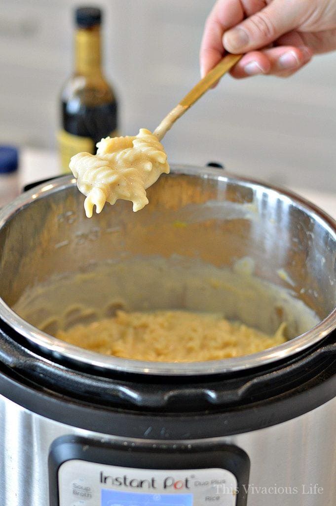 Creamy Mac and cheese being spooned out of an Instant Pot