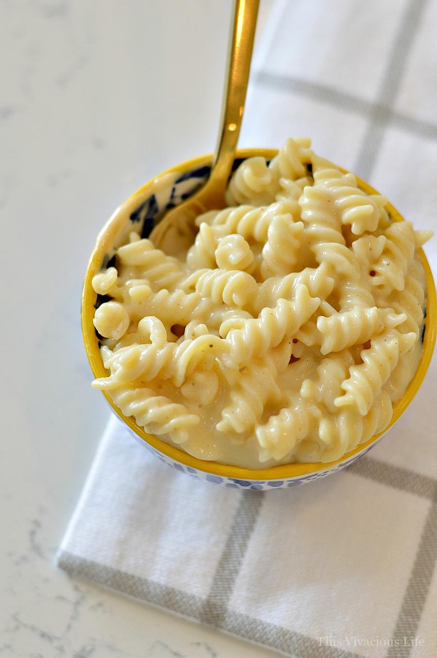 Overhead shot of gluten-free Mac and cheese in a bowl with gold spoon