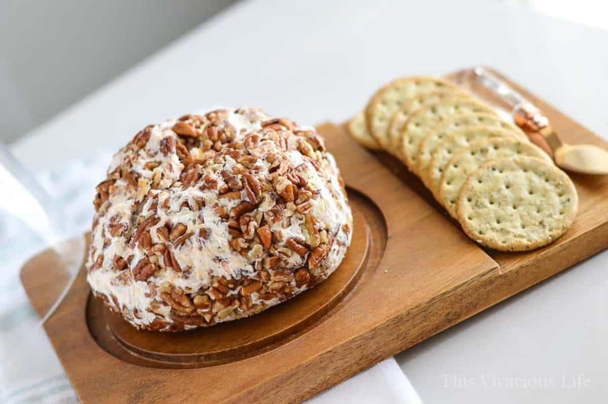 BEST cheeseball on a wood platter with crackers