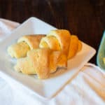 Gluten-free crescent rolls on a white plate