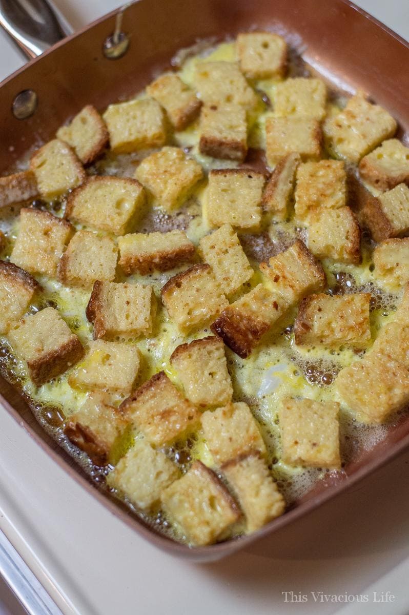 French toast bites frying in a pan with butter