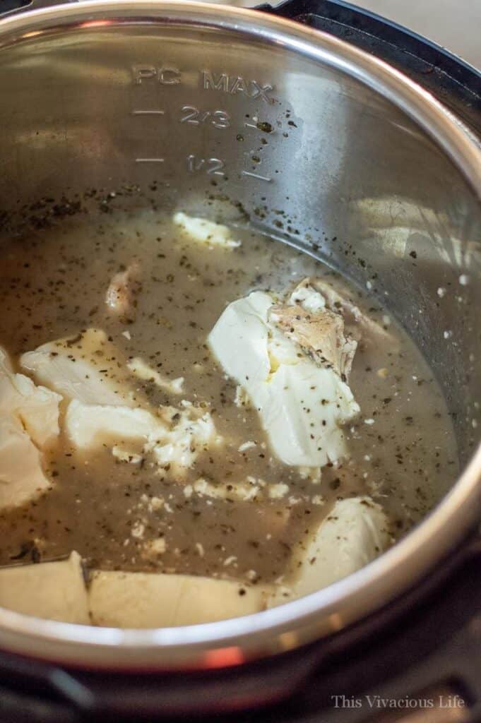 Italian chicken recipe being made in an instant pot with chicken and ingredients inside