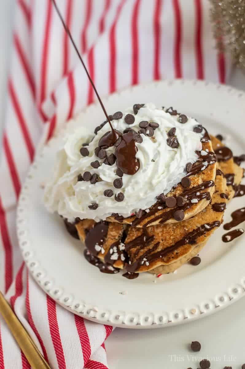 Christmas pancakes with chocolate drizzle being poured on